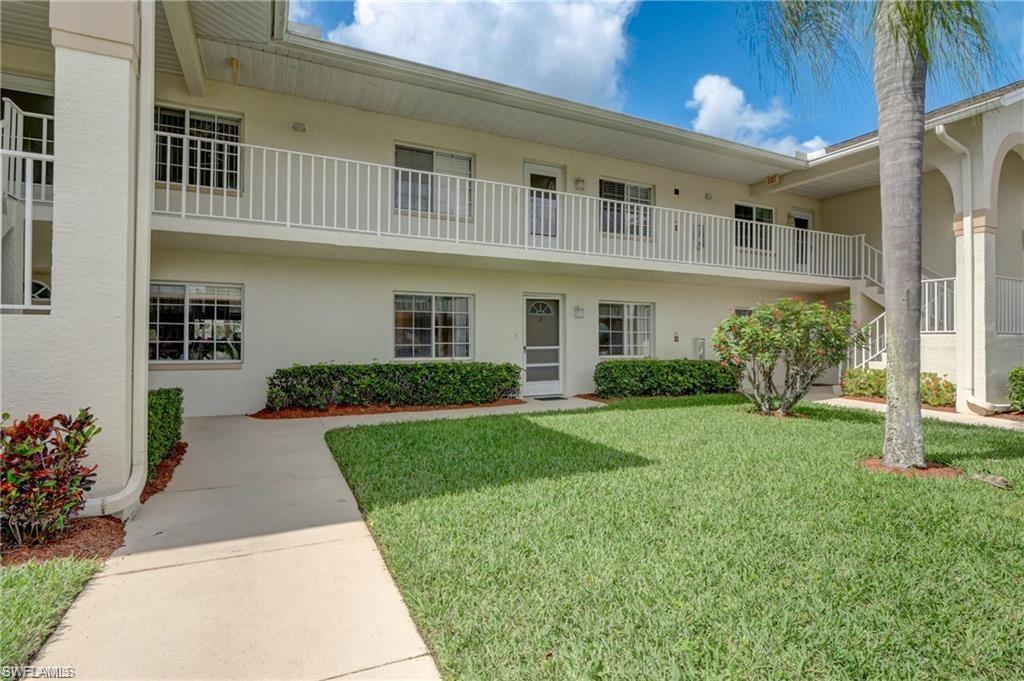 153 Gabriel Circle, Unit 3003 Naples, FL 34104 - Photo 4 of 38 a front view of a house with garden