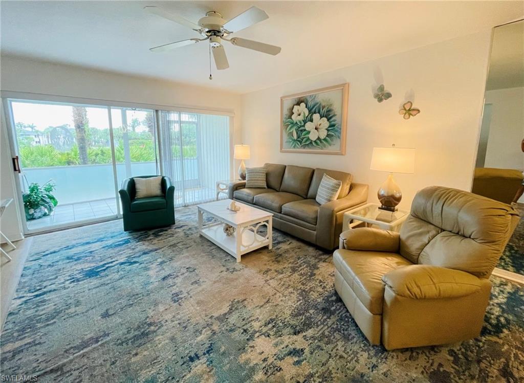 153 Gabriel Circle, Unit 3003 Naples, FL 34104 - Photo 6 of 38 a living room with furniture and a large window