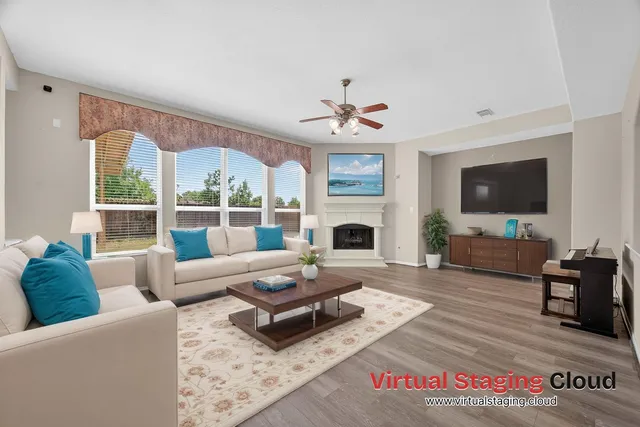 a living room with furniture a fireplace and a flat screen tv