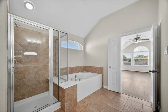 a bathroom with a tub and shower