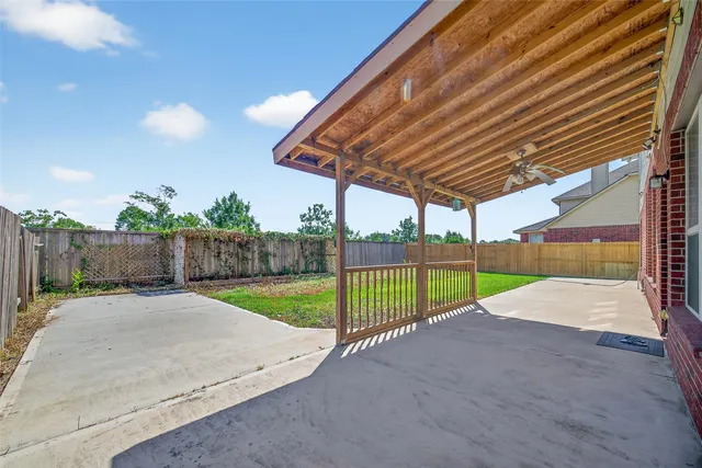 a view of a backyard with wooden fence