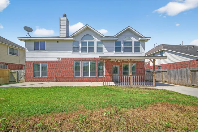 a front view of a house with a garden and deck