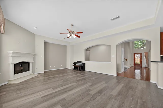 a view of empty room with wooden floor and fireplace