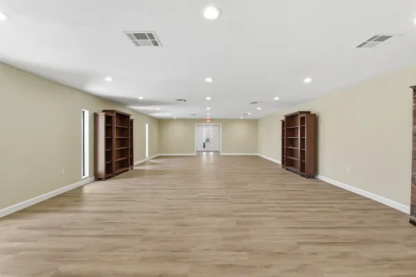 an empty room with wooden floor