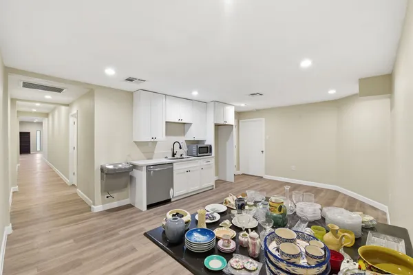 a kitchen with a sink cabinets and wooden floor