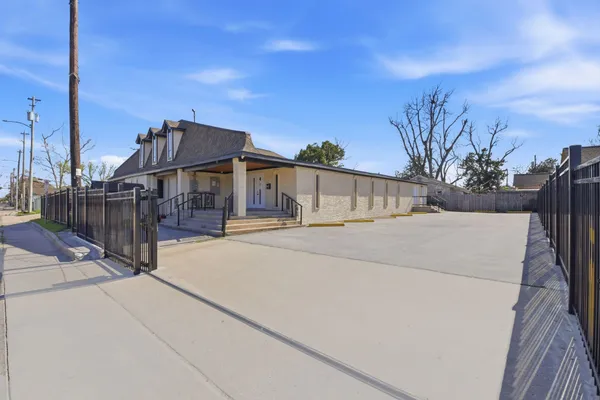 a view of a house with wooden fence