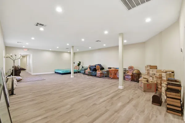 a view of empty room with furniture and wooden floor