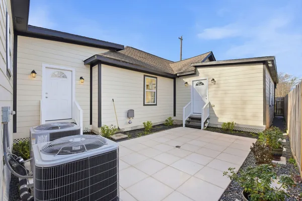 a view of a patio with couches chairs and potted plants
