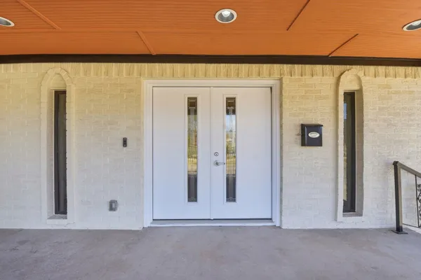 an empty room with wooden floor and window