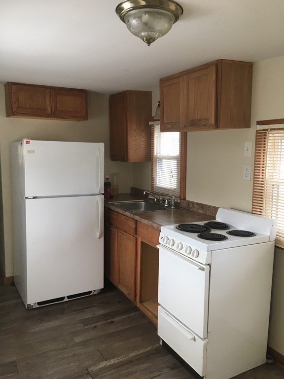 8 Pioneer Way Springfield, MA 01119 - Photo 2 of 9 a kitchen with a stove a refrigerator and a sink