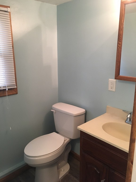 8 Pioneer Way Springfield, MA 01119 - Photo 3 of 9 a white toilet sitting next to a bathroom sink