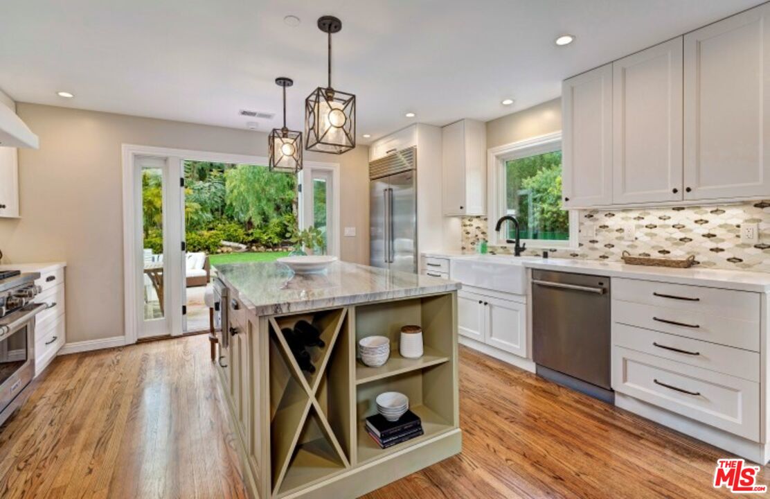 20779 Big Rock Drive Malibu, CA 90265 - Photo 13 of 37 a kitchen with stainless steel appliances granite countertop a stove a sink dishwasher and a wooden floor