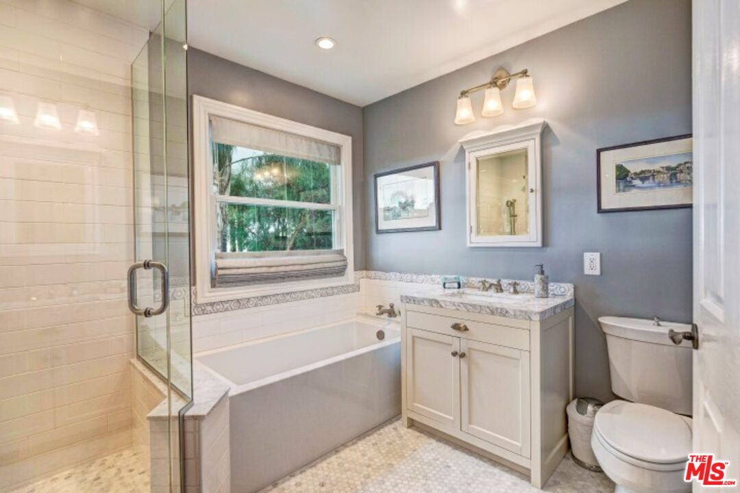 20779 Big Rock Drive Malibu, CA 90265 - Photo 23 of 37 a bathroom with a granite countertop toilet a sink and a bathtub