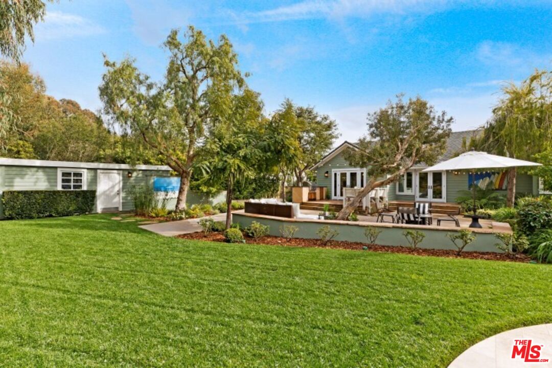 20779 Big Rock Drive Malibu, CA 90265 - Photo 33 of 37 a front view of a house with swimming pool having outdoor seating