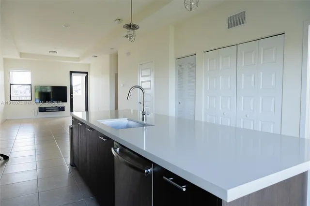 a kitchen with a sink and refrigerator