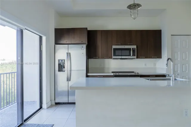 a kitchen with a refrigerator and a microwave