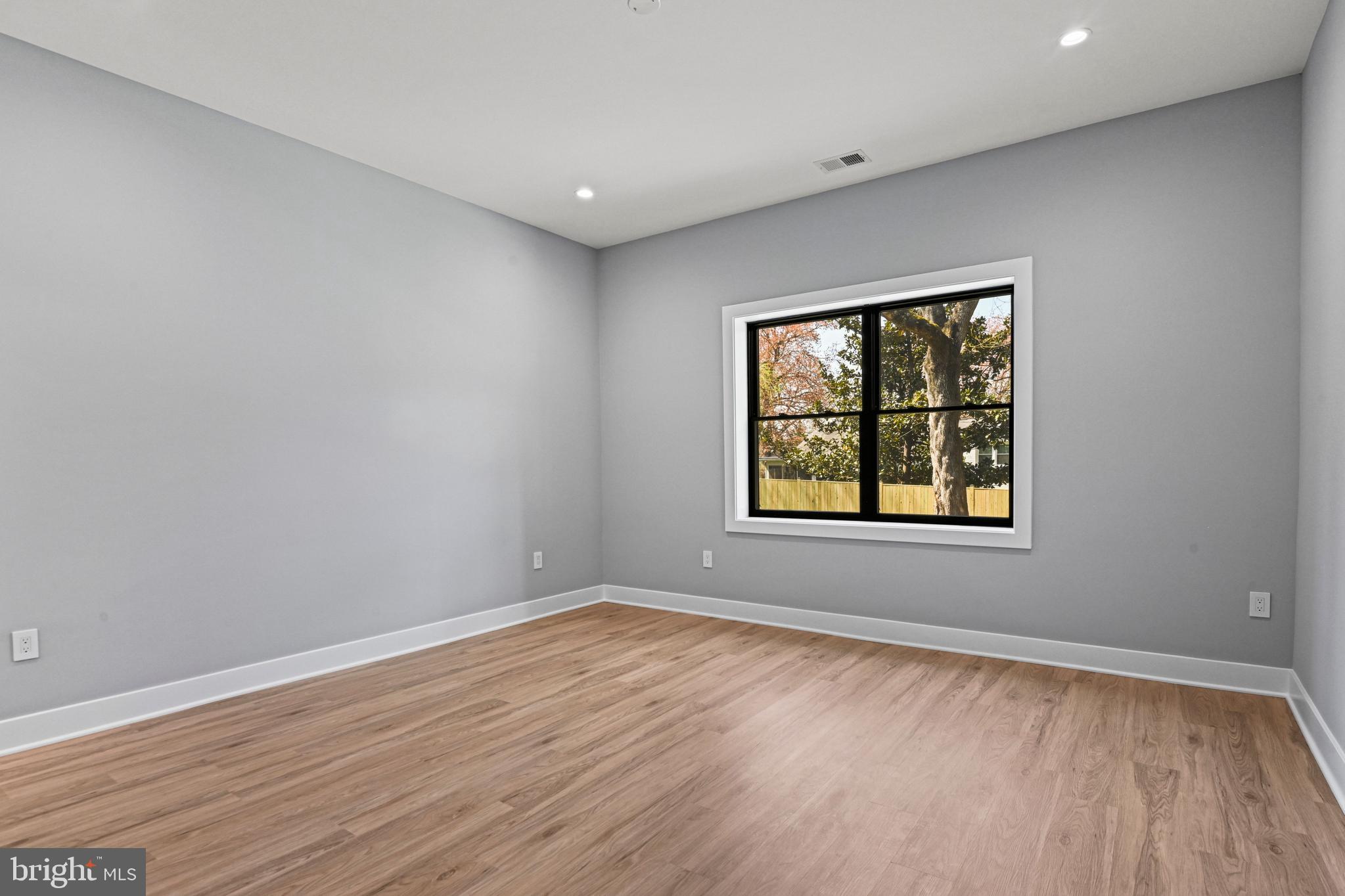 1052 Balls Hill Road McLean, VA 22101 - Photo 49 of 64 a view of an empty room with wooden floor and a window