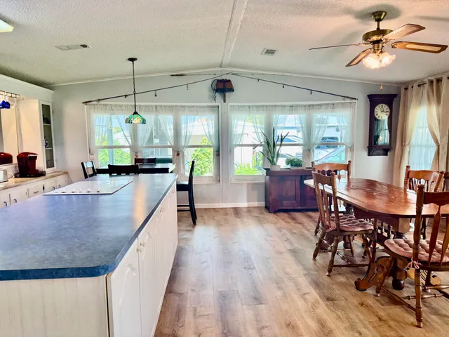 a kitchen with stainless steel appliances granite countertop sink stove and wooden cabinets