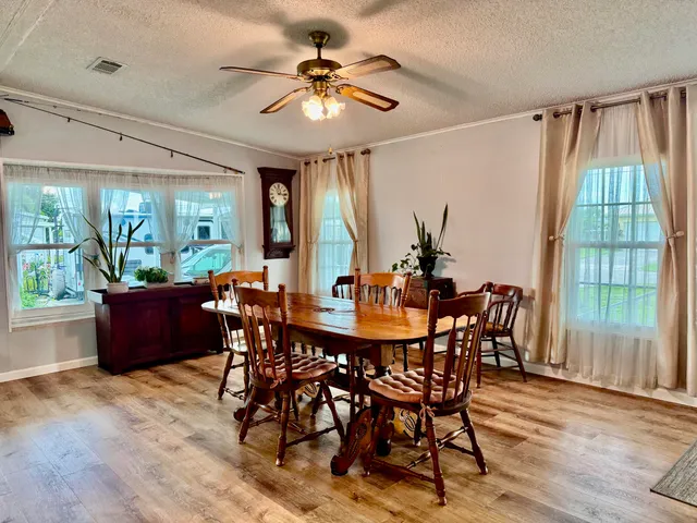 a view of a dining room with furniture window and wooden floor
