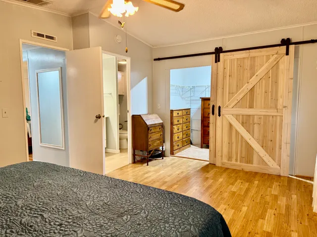 a bedroom with a bed and a chandelier