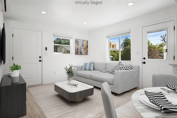 a living room with furniture and a potted plant