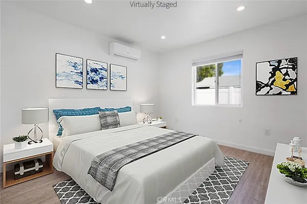 a bedroom with a bed and a painting on the wall