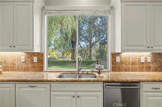 a kitchen with granite countertop a sink and a window