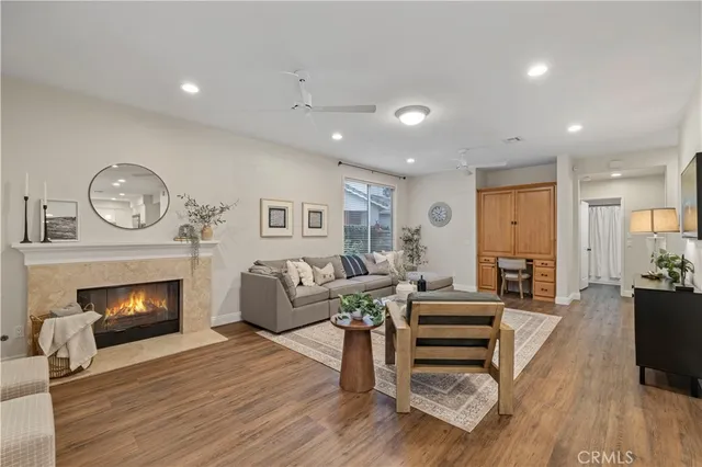a living room with furniture a fireplace and a flat screen tv