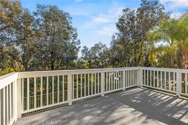 a balcony with wooden floor and fence