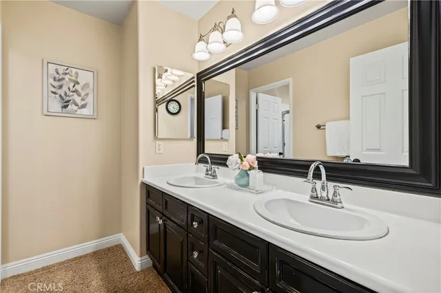 a bathroom with a double vanity sink and a mirror
