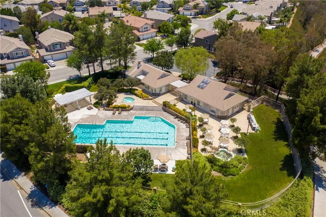 an aerial view of residential house with outdoor space and swimming pool
