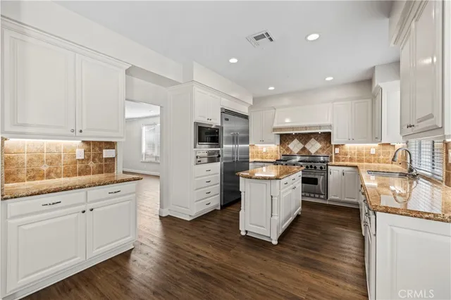 a kitchen with stove cabinets and refrigerator