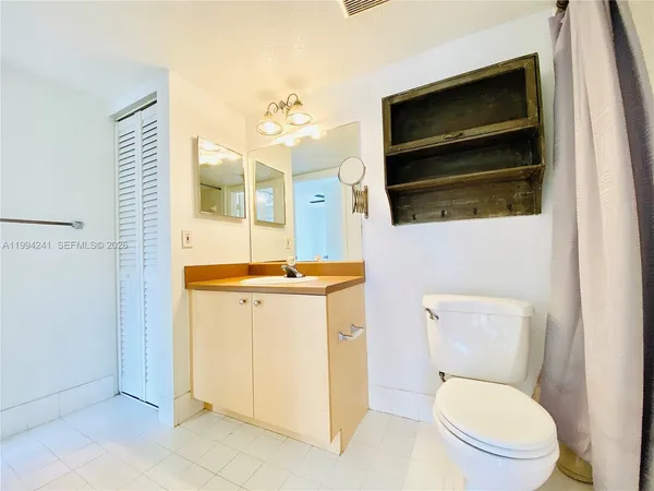 a bathroom with a toilet a sink and a mirror