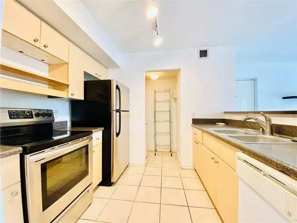 a kitchen with a sink a stove and refrigerator