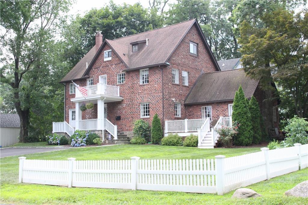 48 Dry Hill Road Norwalk, CT 06851 - Photo 1 of 1 a front view of a house with a yard and a garden