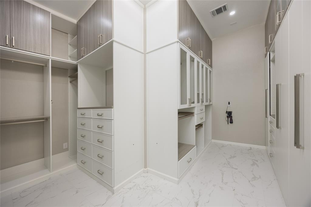 918 Sydney Lane Allen, TX 75013 - Photo 18 of 40 Customizable walk-in closet featuring extensive built-in cabinetry, hanging rods, and drawers