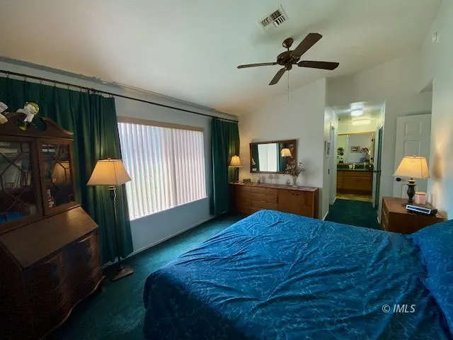 a bed room with a bed window and dresser