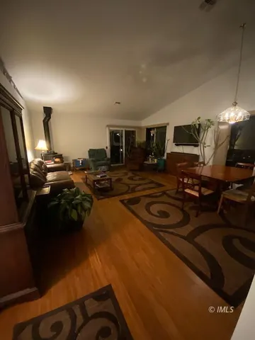 a kitchen with sink a refrigerator and chairs