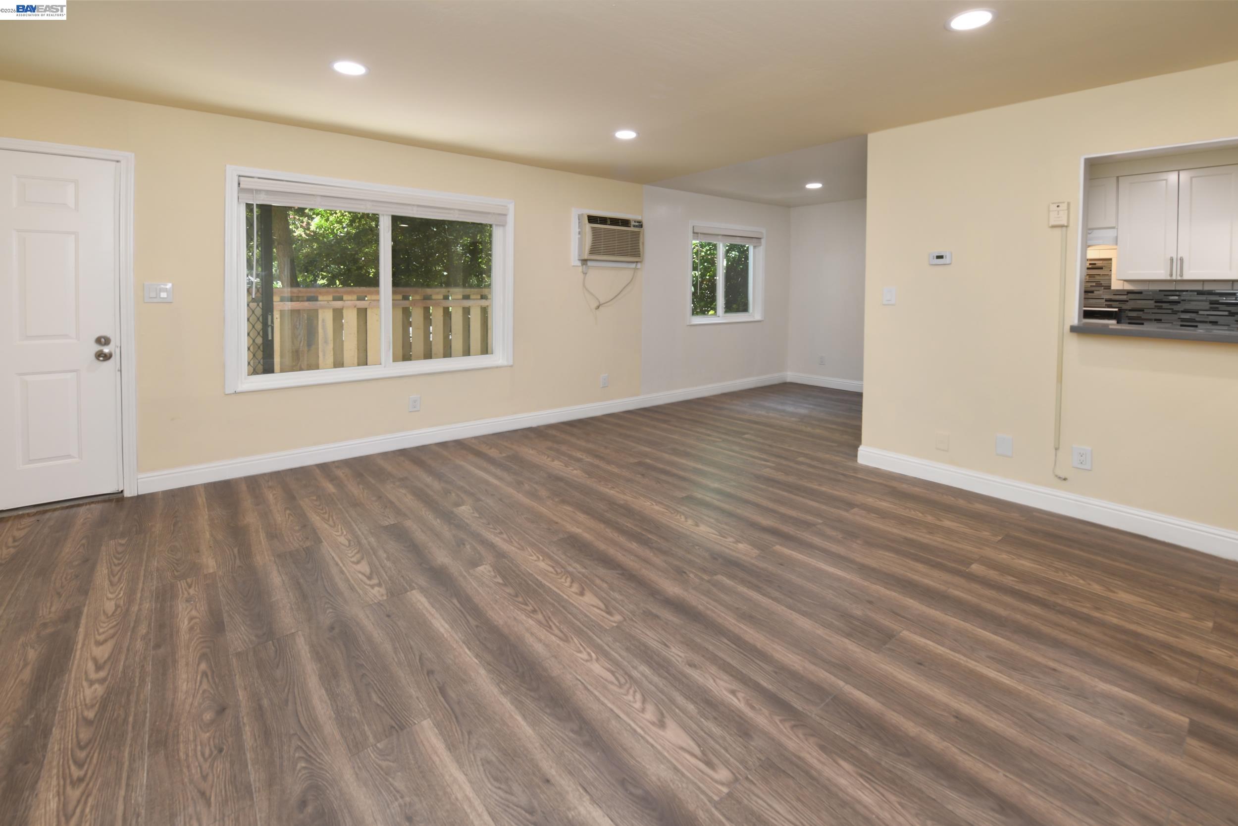205 Muir Road Martinez, CA 94553 - Photo 8 of 20 a view of an empty room with wooden floor and a window