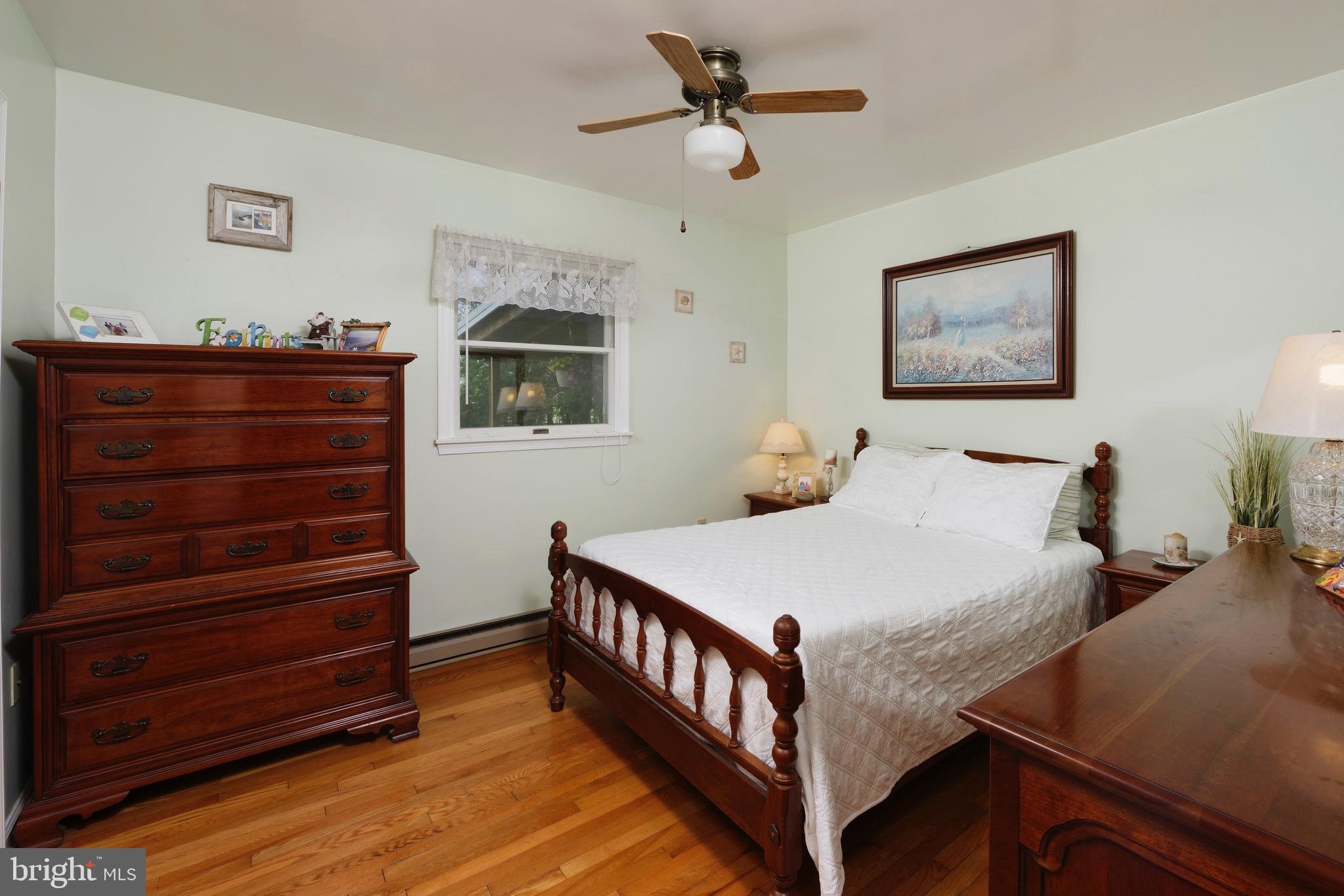 21088 Unison Road Middleburg, VA 20117 - Photo 14 of 66 a bedroom with a bed and a chandelier