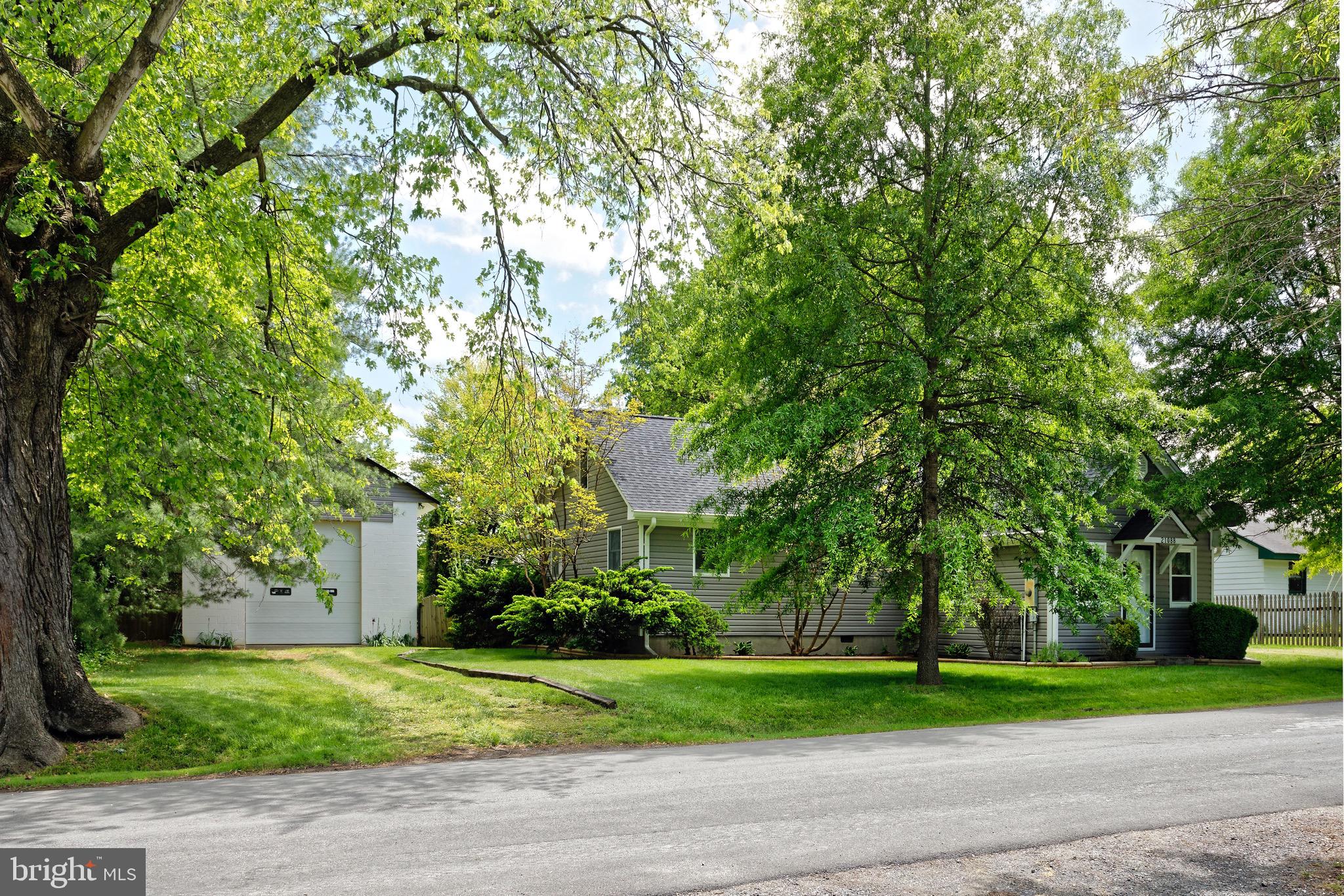 21088 Unison Road Middleburg, VA 20117 - Photo 3 of 66 a front view of a house with a yard and large trees