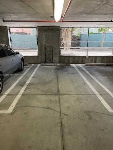 a kitchen with granite countertop a refrigerator and a sink