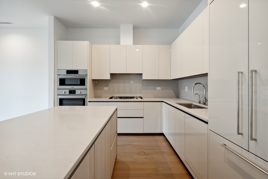 323 South Racine Avenue, Unit 6A Chicago, IL 60607 - Photo 13 of 28 a kitchen with stainless steel appliances granite countertop a refrigerator and white cabinets