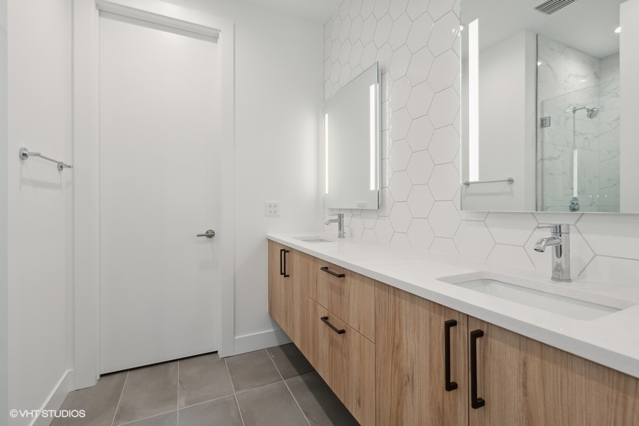 323 South Racine Avenue, Unit 6A Chicago, IL 60607 - Photo 18 of 28 a bathroom with a double vanity sink and a mirror