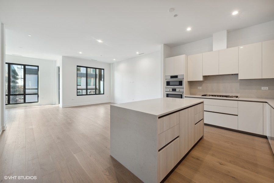 323 South Racine Avenue, Unit 6A Chicago, IL 60607 - Photo 3 of 28 a kitchen with granite countertop white cabinets and white appliances
