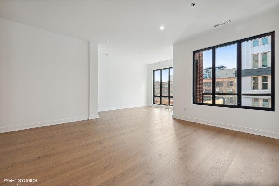 323 South Racine Avenue, Unit 6A Chicago, IL 60607 - Photo 7 of 28 a view of an empty room with a window and wooden floor