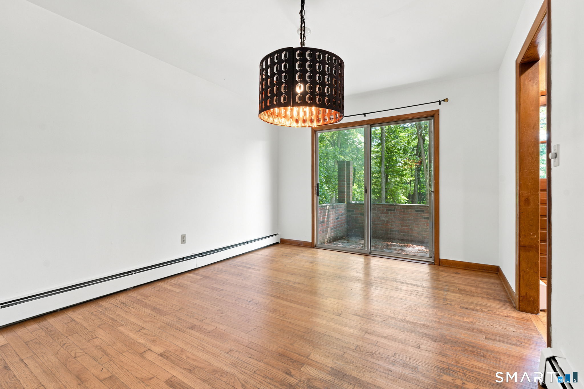 448 Mixville Road Cheshire, CT 06410 - Photo 10 of 32 a view of an empty room with wooden floor and a window