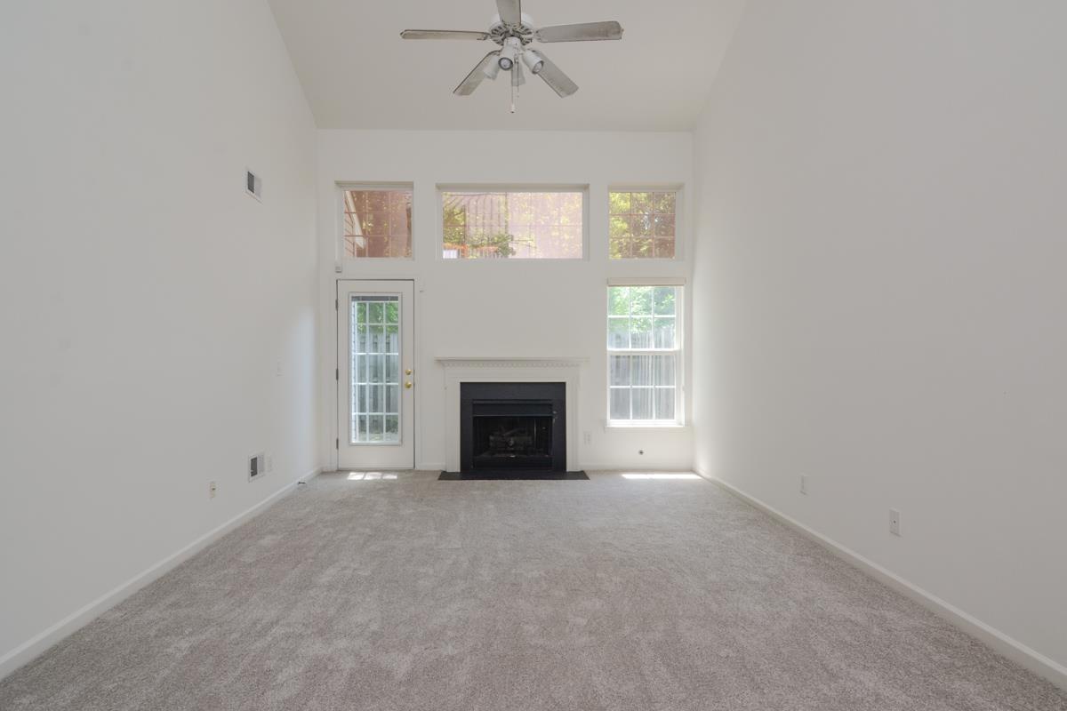 3401 Anderson Road, Unit 52 Antioch, TN 37013 - Photo 9 of 24 an empty room with a fireplace and windows