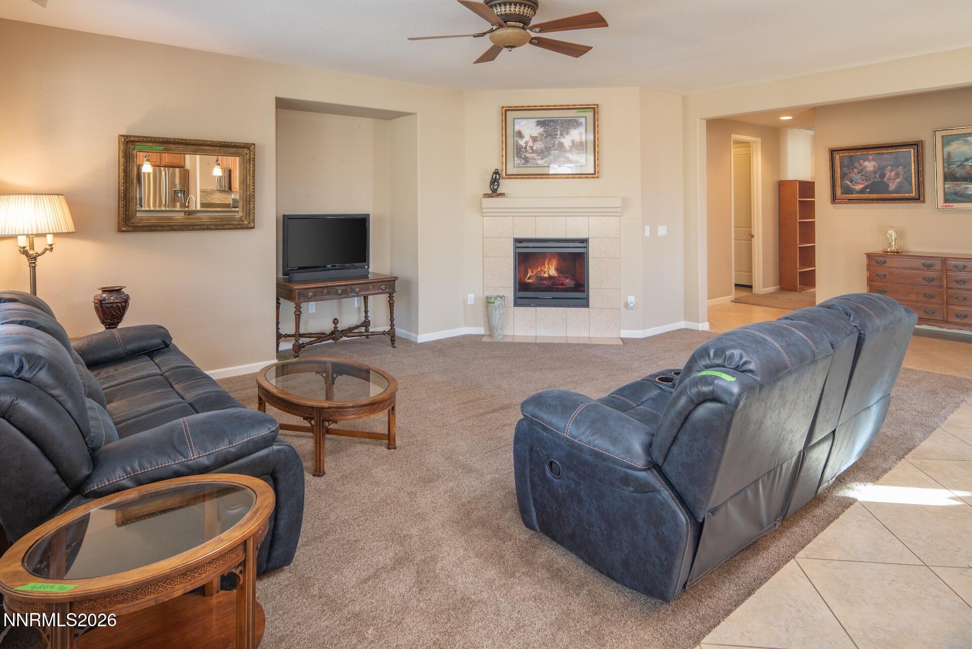 1413 Bluewood Drive Reno, NV 89523 - Photo 11 of 42 a living room with furniture a flat screen tv and a fireplace