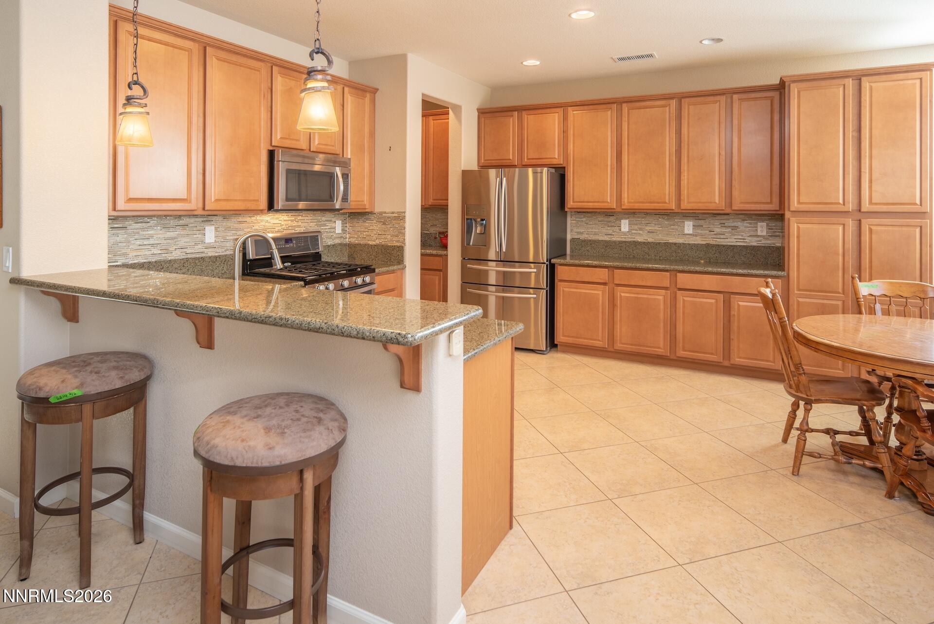 1413 Bluewood Drive Reno, NV 89523 - Photo 15 of 42 a kitchen with stainless steel appliances a sink and a refrigerator